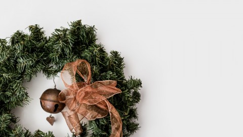 green Christmas wreath on white surface